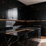 A photograph of a luxurious kitchen featuring perfectly illuminated matte black cabinets and a black marble island, illustrating the successful application of high lumen compensation to reveal surface depth and texture.