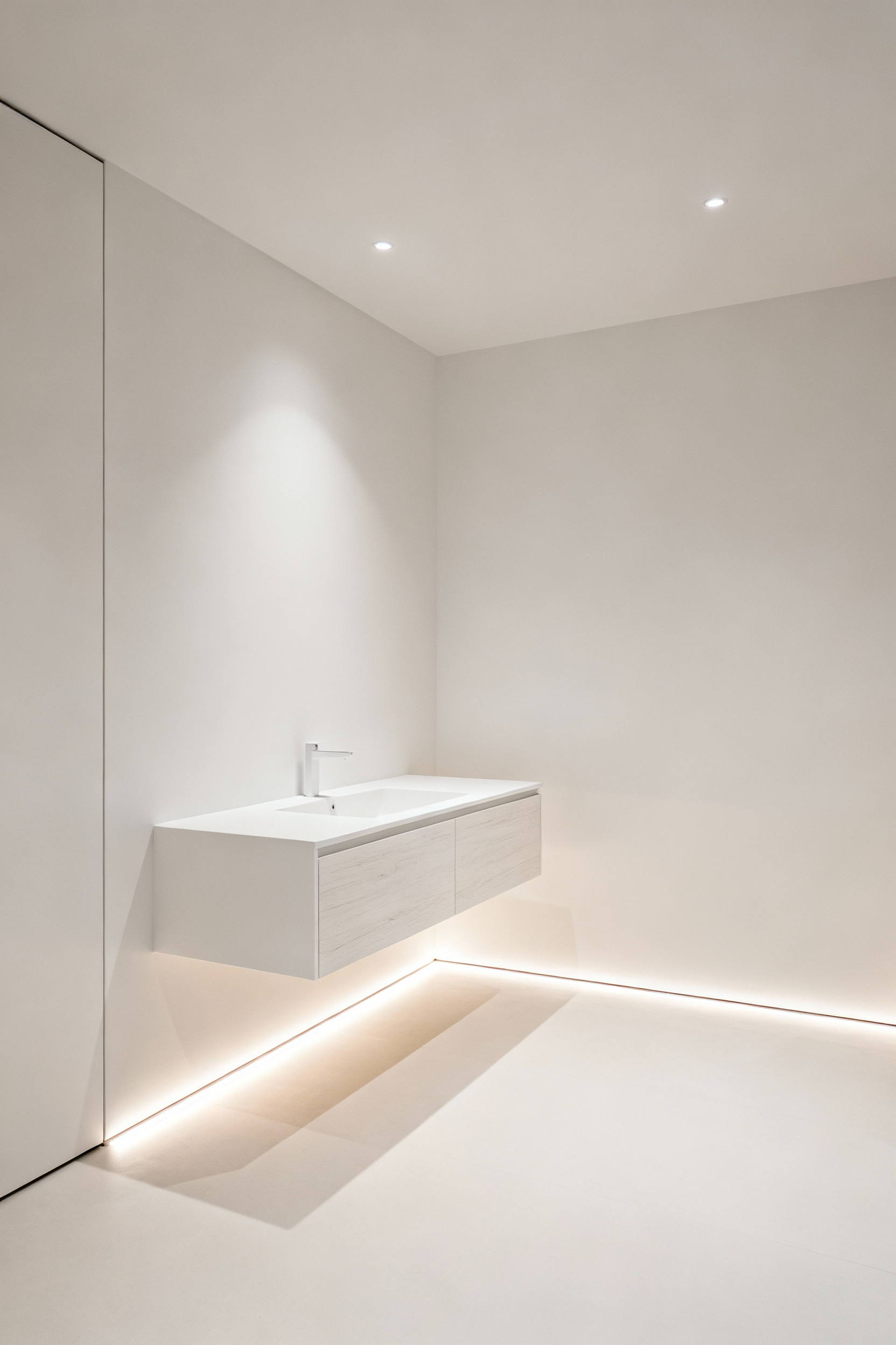 Modern small bathroom featuring a floating vanity with a clear floor space beneath, enhancing visual openness and showcasing subtle under-vanity lighting.